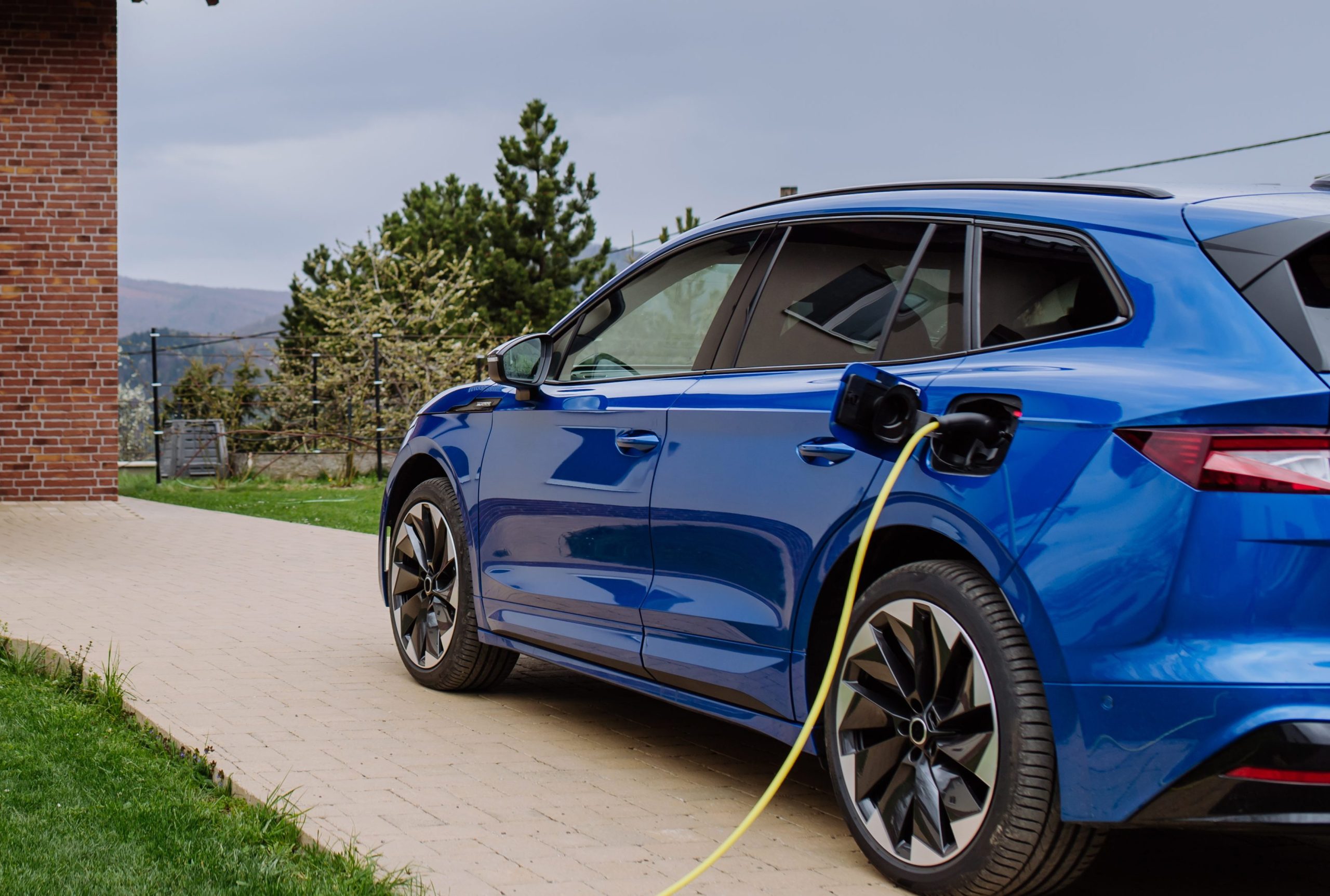 close-up-of-electric-car-charging-near-family-hous-2023-11-27-04-53-32-utc-e1728774062639